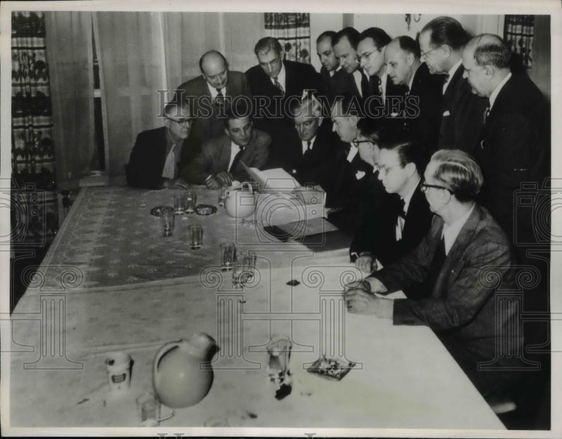 Load image into Gallery viewer, 1950 Press Photo Company negotiators looking of copy of agreement
