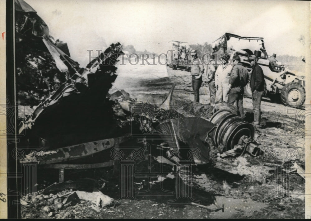 1970 Press Photo of workers looking over one the seven wrecked semi trucks on