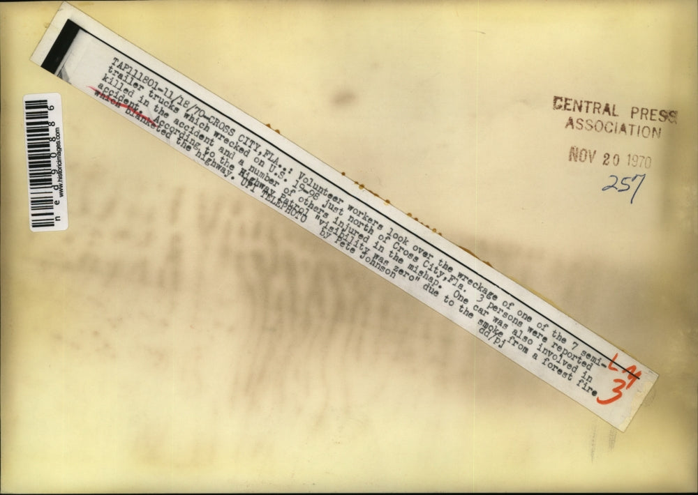 1970 Press Photo of workers looking over one the seven wrecked semi trucks on