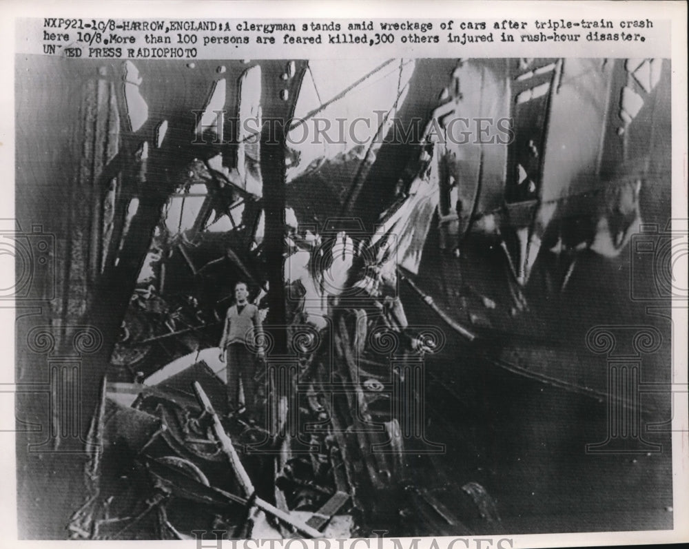 1952 Press Photo of clergyman standing on the wreckage of train derailment that- Historic Images