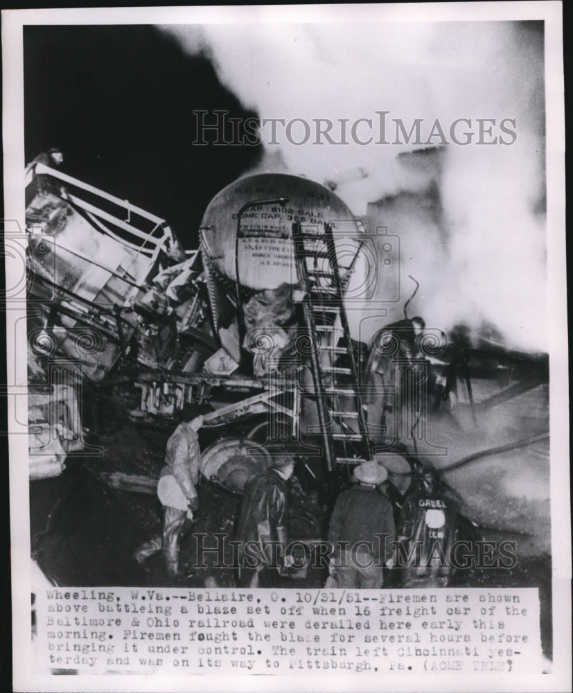 1951 Press Photo Firemen seen battling a blaze set off by derailed freight car