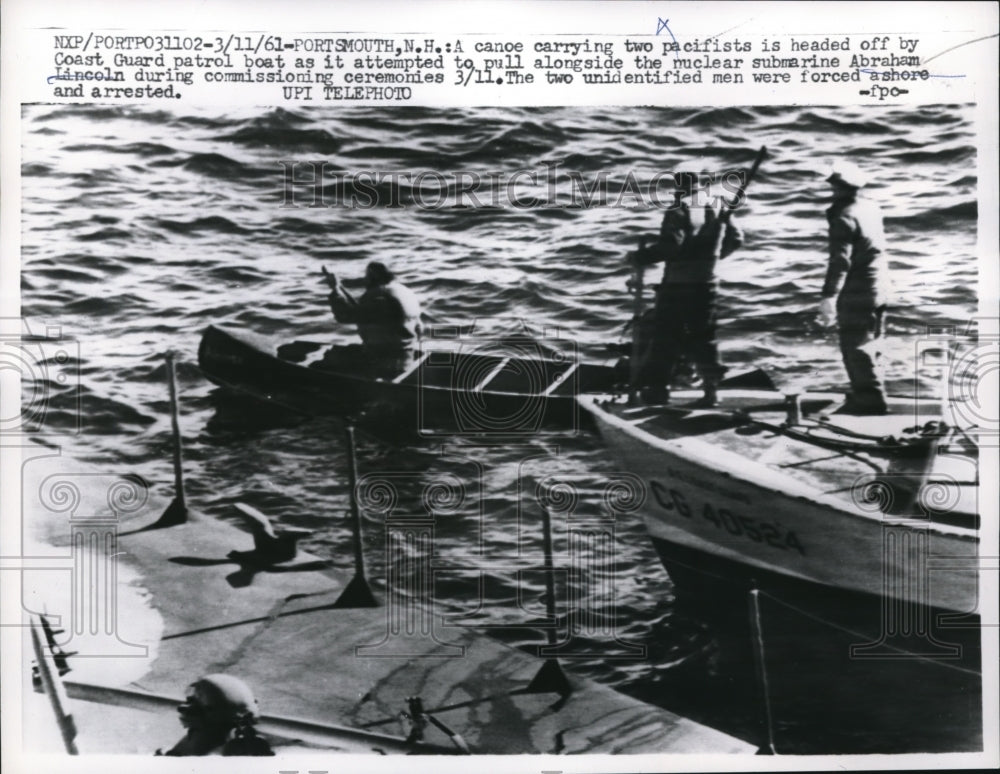 1961 Press Photo of Coast Guardsman heads off two pacifists trying to pull along- Historic Images