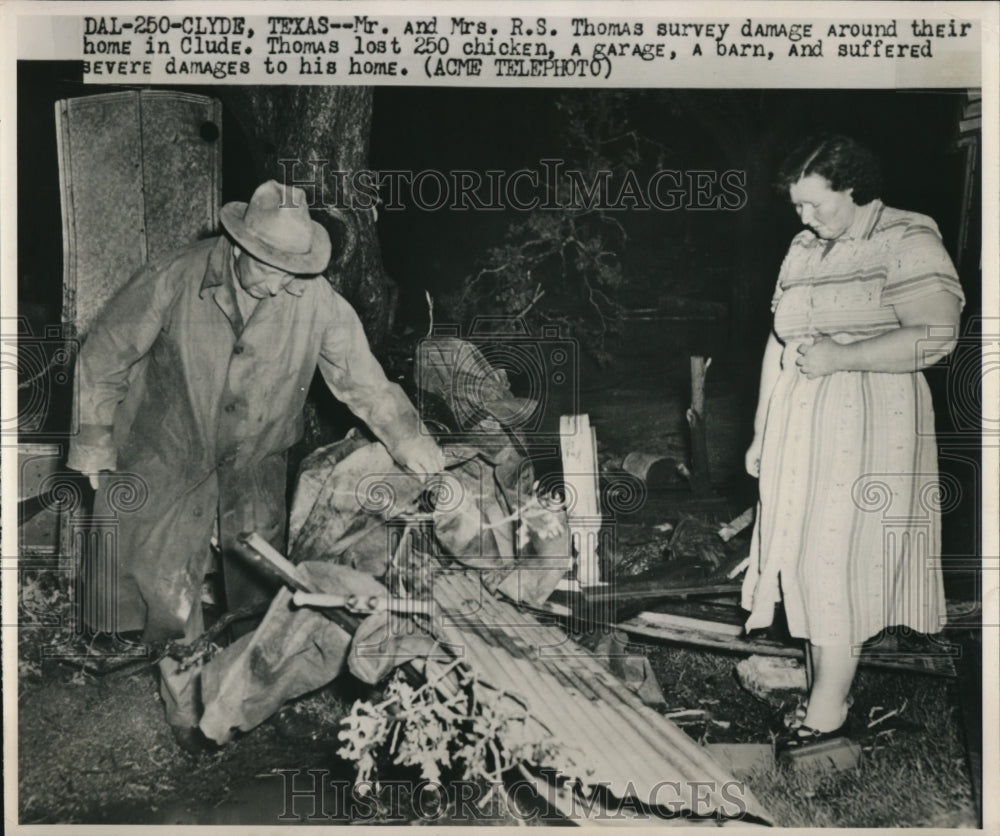 1950 Press Photo Mr.and Mrs.R.S. Thomas survey the damage around their home