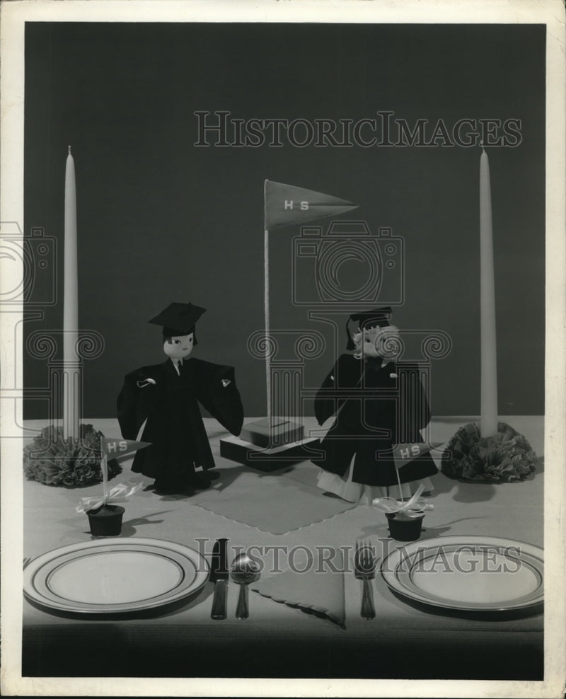 Load image into Gallery viewer, 1971 Press Photo Graduation paper dolls for the party displayed on the table
