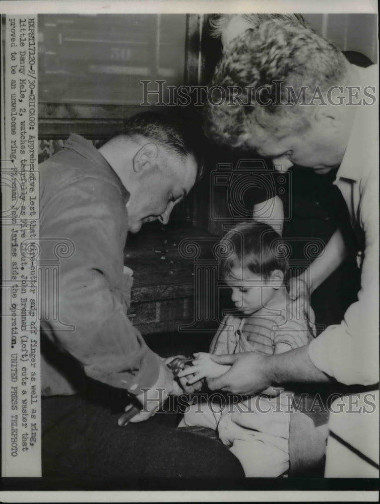 Load image into Gallery viewer, 1950 Press Photo of a fireman cutting a washer off of the finger of Danny Mele.
