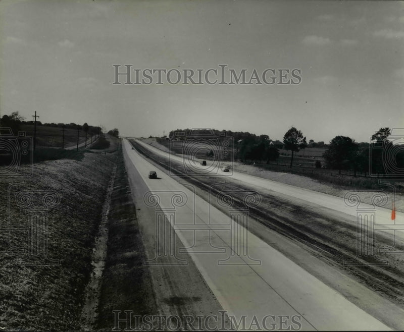 Load image into Gallery viewer, 1958 Press Photo of an advertisement for the Ohio Turnpike.
