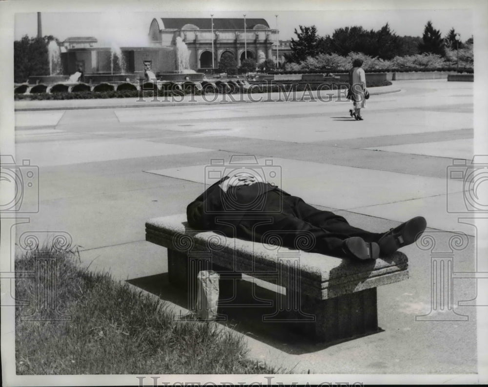 1958 Press Photo A man taking a nap on a bench in the Capital Plaza - ned94838