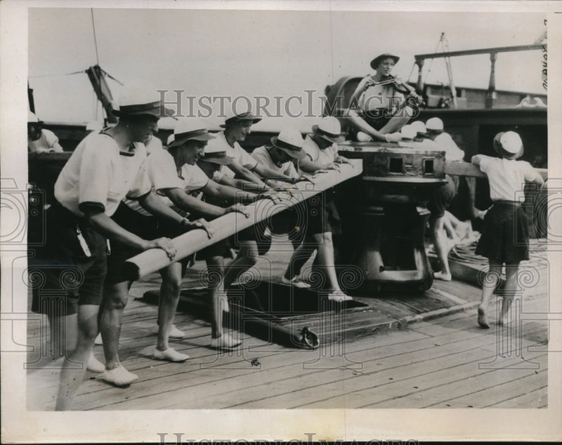 Load image into Gallery viewer, 1937 Press Photo Girl Guides England on ship Implacable &amp; capstan on Foudroyant
