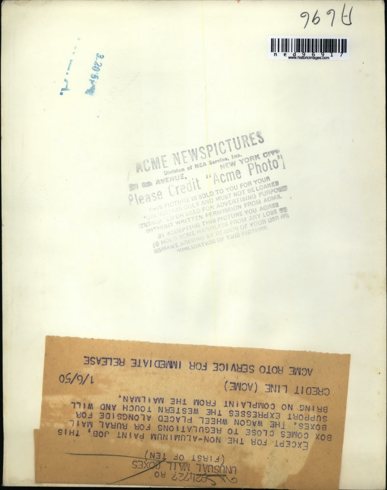 Load image into Gallery viewer, 1950 Press Photo Wagon wheel decor on a postal box
