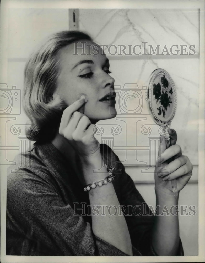 Load image into Gallery viewer, 1958 Press Photo Woman Applies Flesh Colored Spot Bandaid to Face

