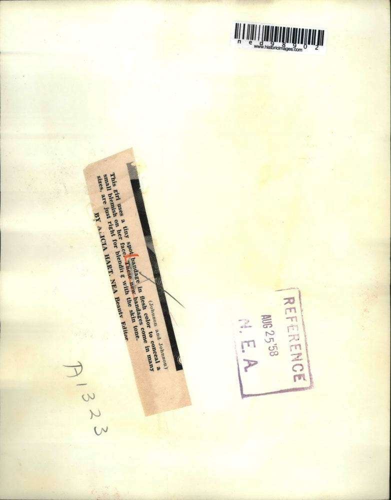 1958 Press Photo Woman Applies Flesh Colored Spot Bandaid to Face