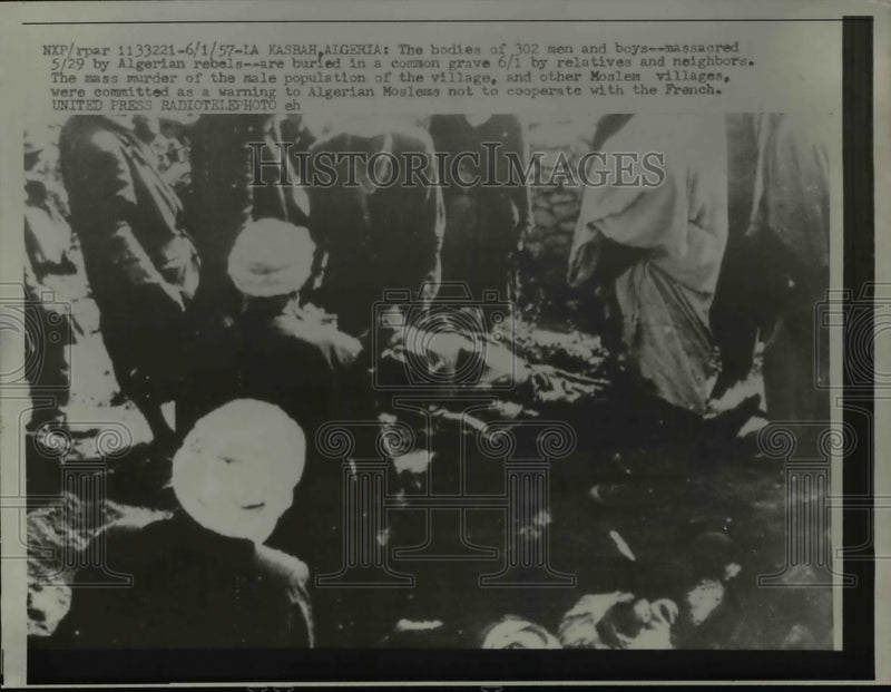 Load image into Gallery viewer, 1957 Press Photo The Bodies of 302 men and boys massacred buried in common grave
