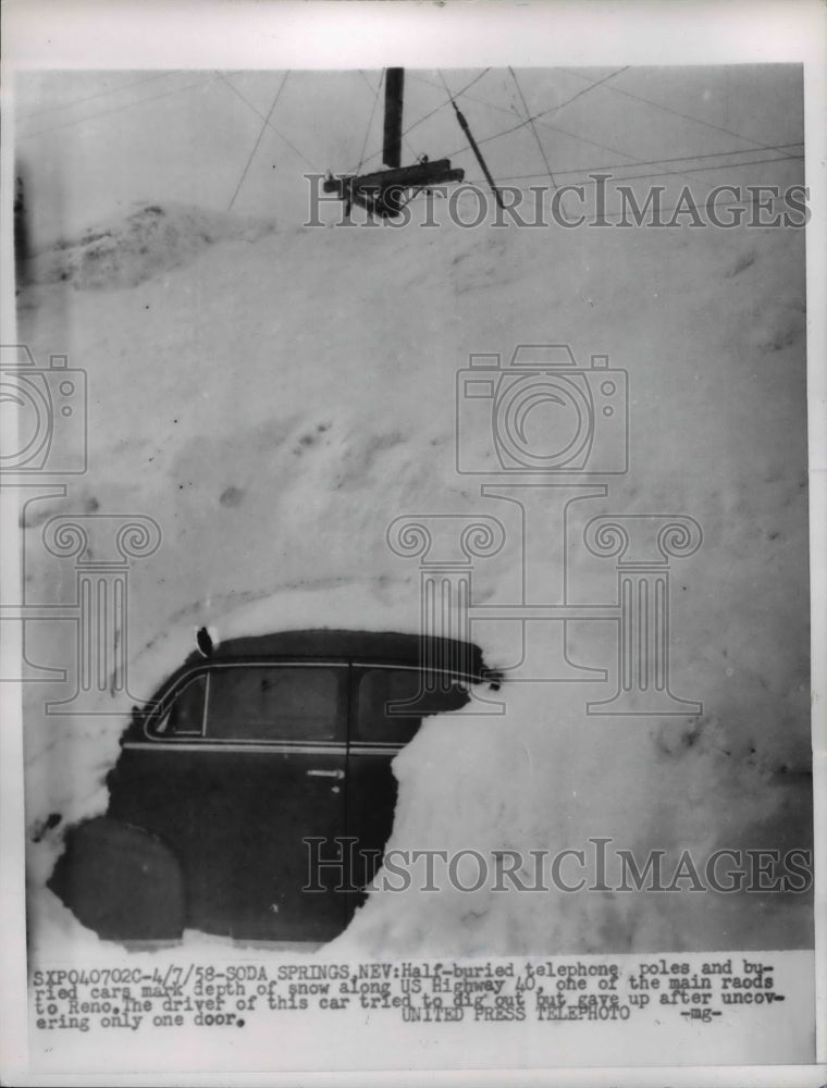 1958 Press Photo Half buried car and telephone pole in snow, Soda Springs, Nevad