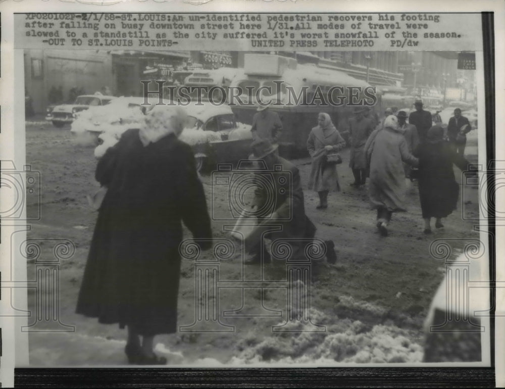 1958 Press Photo St Louis Missouri Pedestrian Regains Footing After Fall on Snow