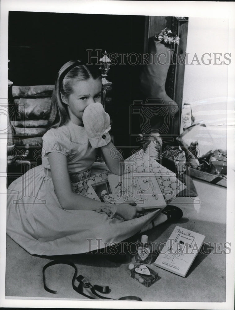 1950 Press Photo Girl in polka dot dress with Christmas presents - nee09781