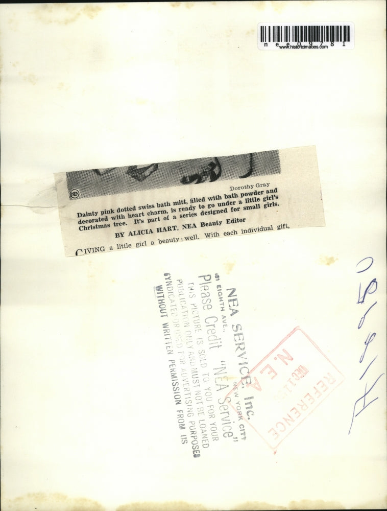 1950 Press Photo Girl in polka dot dress with Christmas presents - nee09781