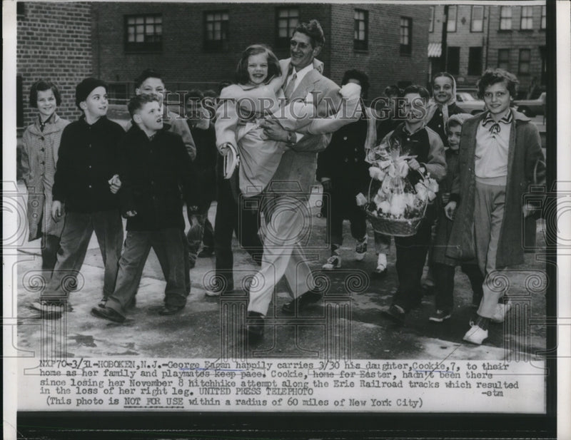 Load image into Gallery viewer, 1956 Press Photo George Eagan carries his daughter Cookie
