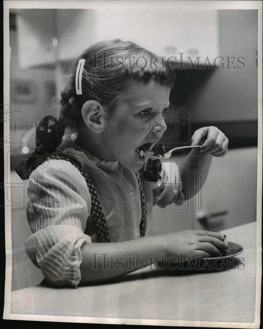 1955 Press Photo Robin Charney taste's her "Robin's Nest Egg" - nee15179