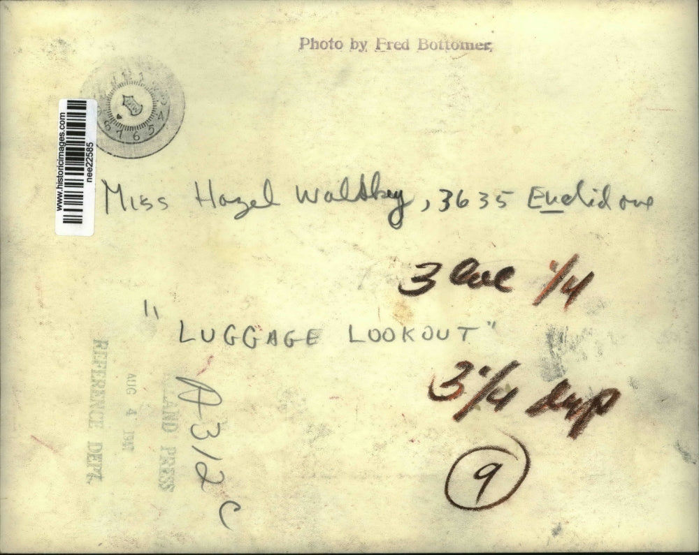 1947 Press Photo Girl Sleeping Atop Luggage, Clothing on Sand - nee22585