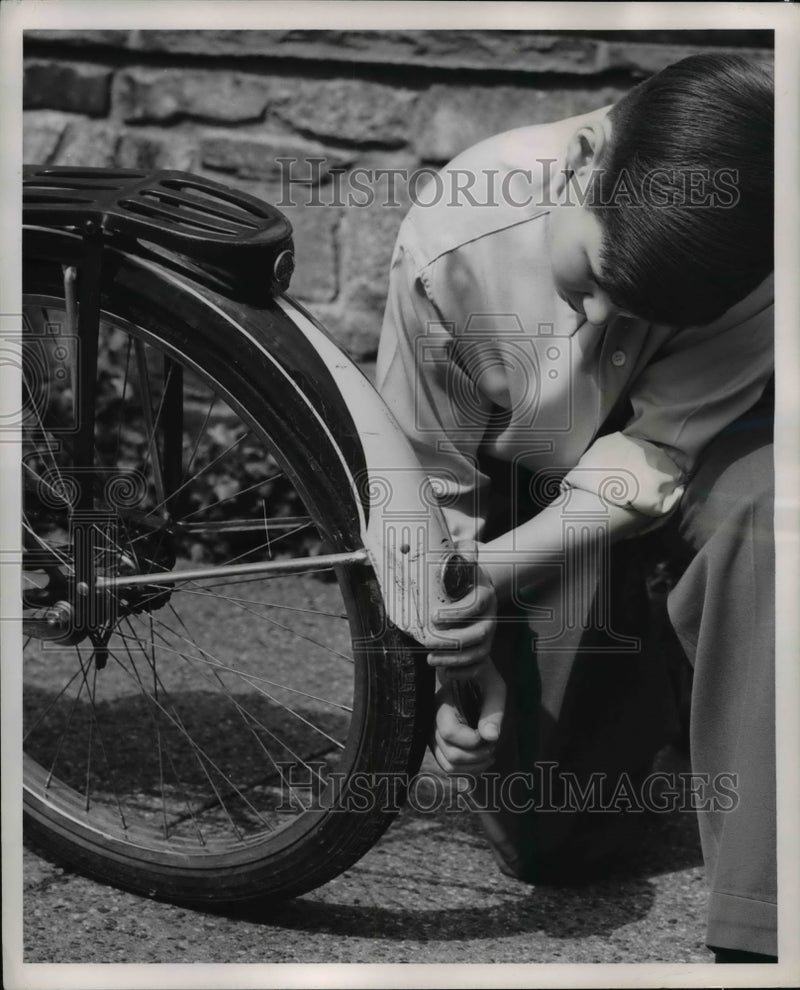 Load image into Gallery viewer, 1951 Press Photo Boy Checks Bike for Light and Tail Reflector
