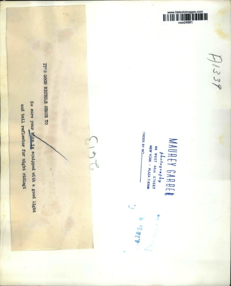 1951 Press Photo Boy Checks Bike for Light and Tail Reflector