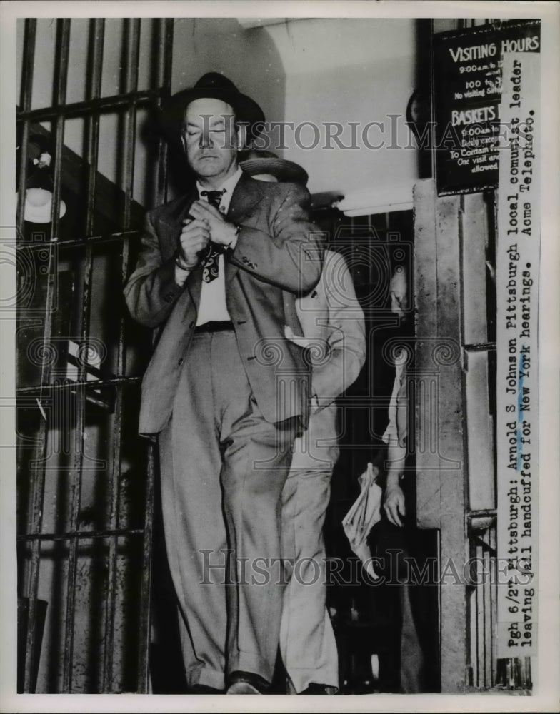 1951 Press Photo Arnold S. Johnson leaving jail handcuffed - nee26943
