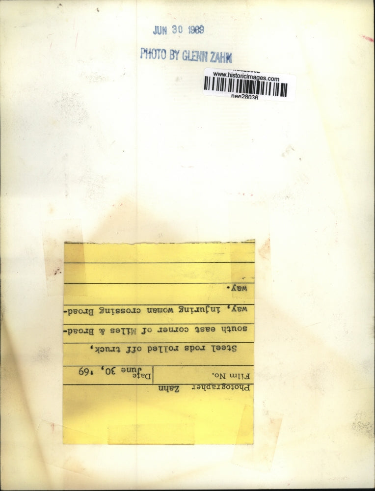 1969 Press Photo Steel Rods Roll Off Truck Injuring Woman Crossing Street