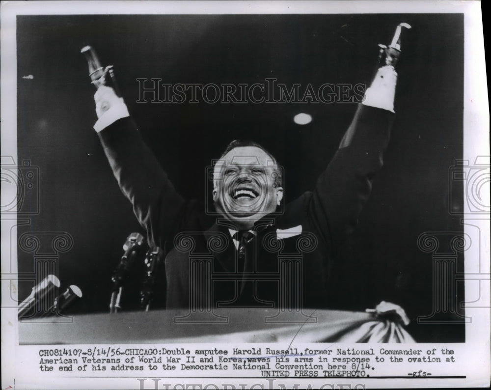 1956 Press Photo Double Amputee Veteran Harold Russell Waves Arms - nee28956