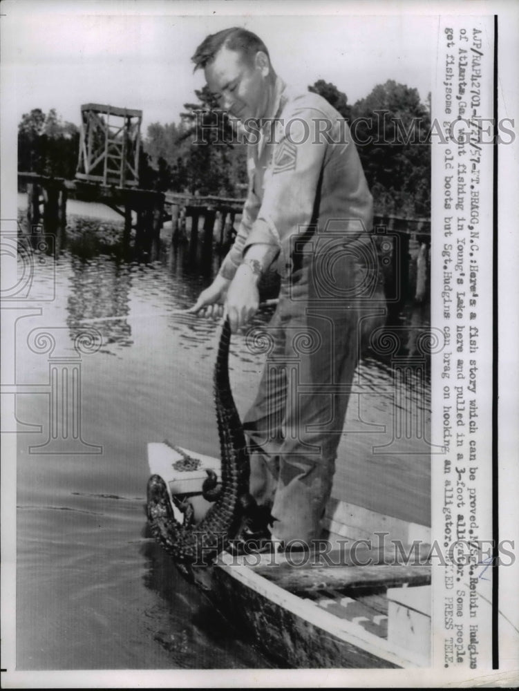 1957 Press Photo Sgt. Reubin Hudgins pulled in 3 foot alligator - nee29561