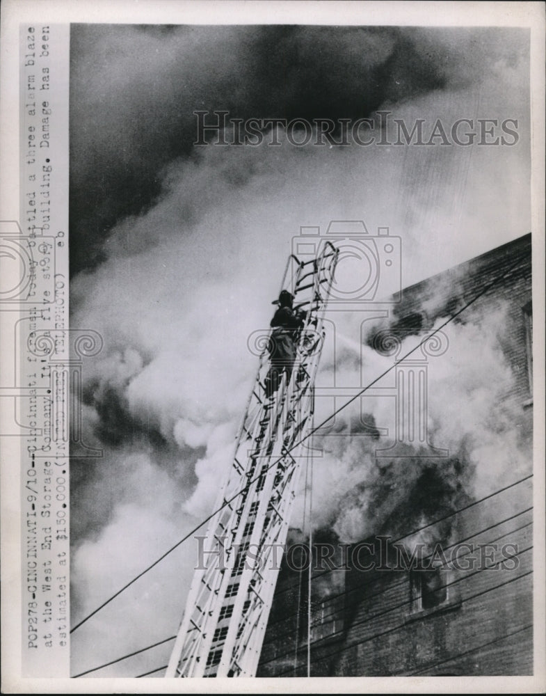 1952 Press Photo Cinnicnnati fireman battle three alarm blaze at Storage Company