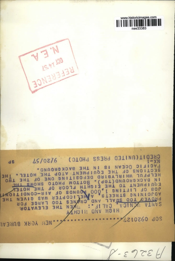 1957 Press Photo Helicopter lifts a 1,000 pound air conditioner, Santa Monica