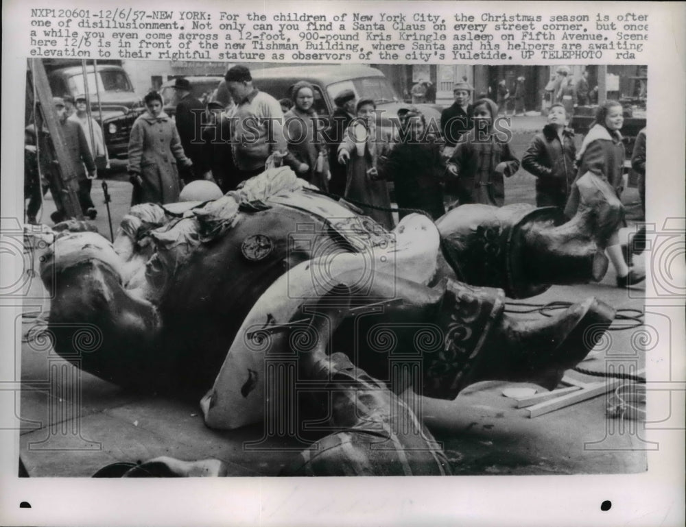1957 Press Photo Santa Claus Statue Lays on Sidewalk, New York - nee36671