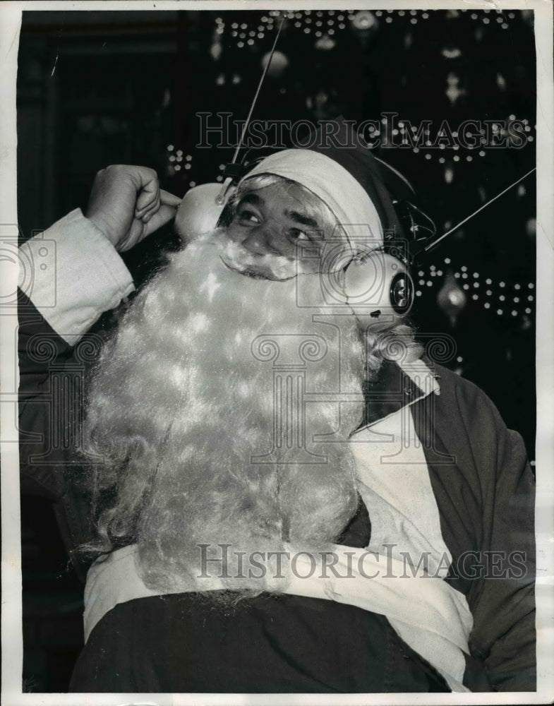 1969 Press Photo Santa Claus listens for latest weather report on headset