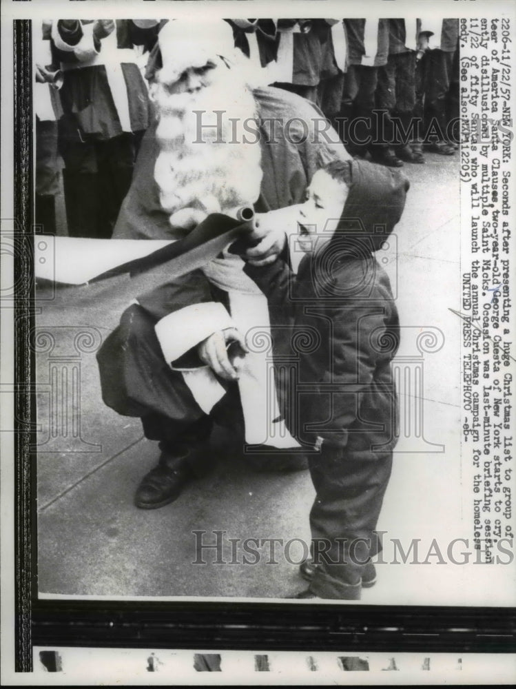 1957 Press Photo Santa Claus Cries as he Presents List