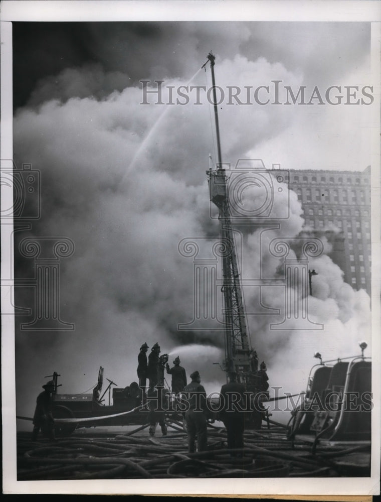 Load image into Gallery viewer, 1951 Press Photo Chicago A water tower hose utilizes advantage of height.
