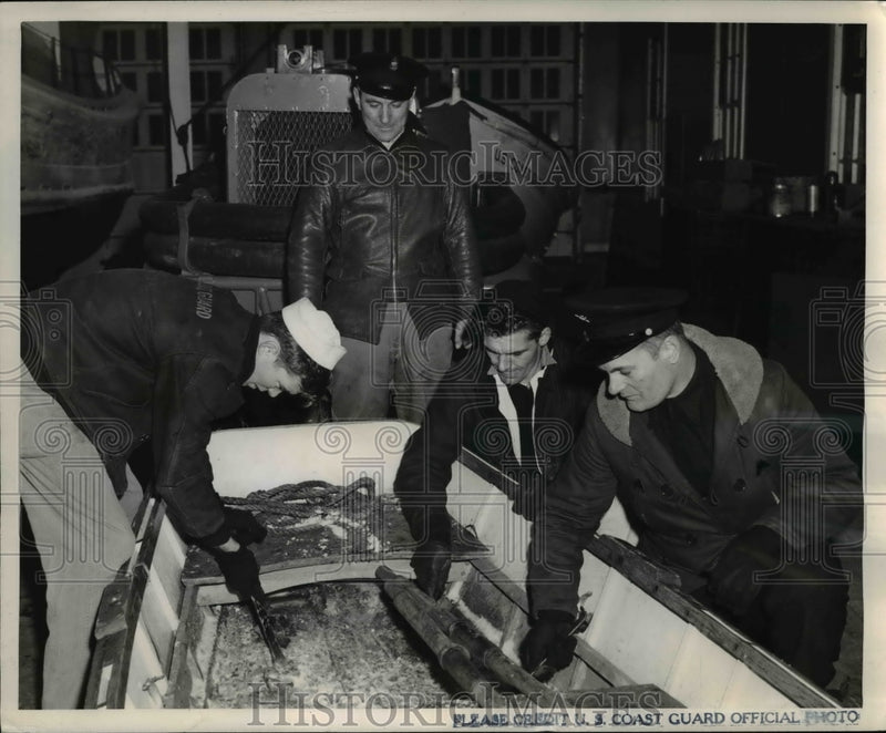 Load image into Gallery viewer, 1946 Press Photo Coast Guardsmen scrape ice from skiff used in rescue operations
