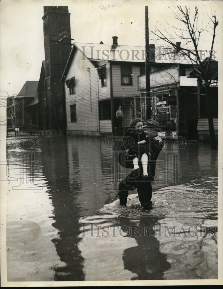 1937 Press Photo Flooded Town, Woman Being Carried Out of Water By Man