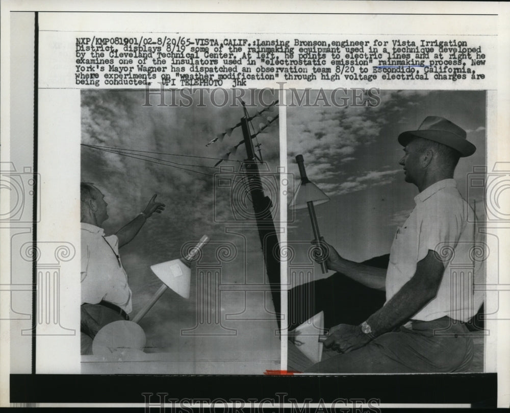 1965 Press Photo Lansing Bronson display some of the rainmaking equipment.