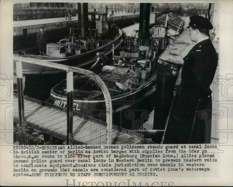 Load image into Gallery viewer, 1948 Press Photo German Policeman Stands Guard at Canal Locks in Berlin
