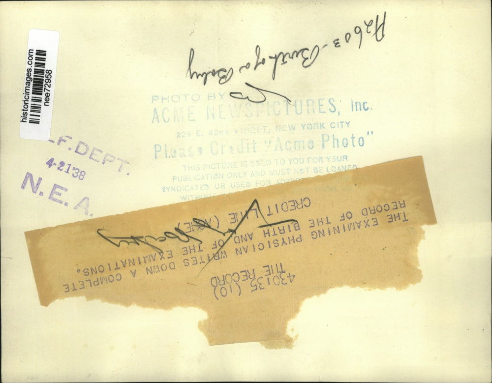 1938 Press Photo Examining Physician writes down complete record of birth