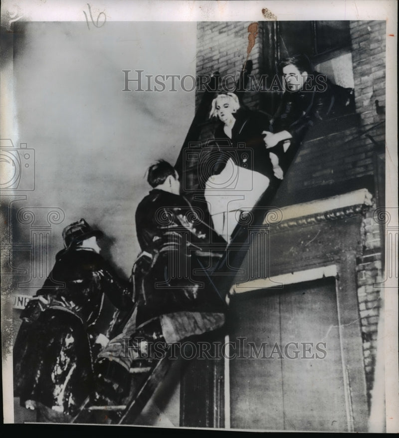 Load image into Gallery viewer, 1950 Press Photo Mrs Lena Dorherty Rescued from 2 Alarm Fire in Boston
