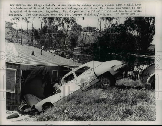 1959 Press Photo Car of Schley Cooper rolled down a hill in the room of a house.- Historic Images