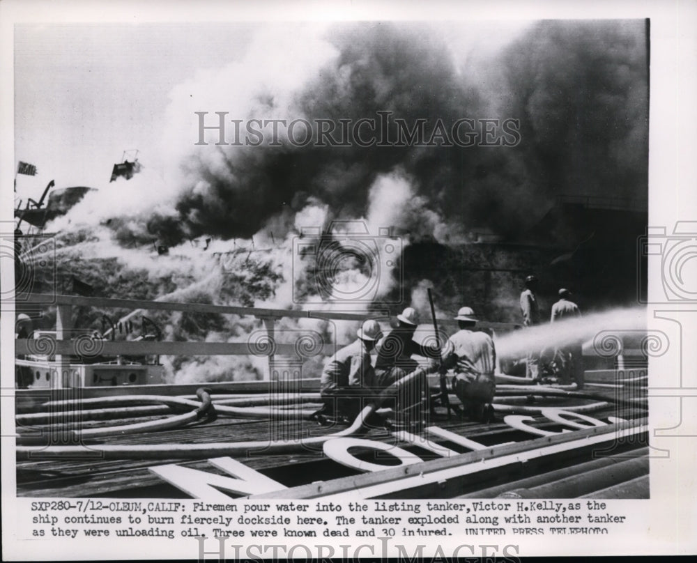 1952 Press Photo Firemen Pour Water Into The Burning Tanker - nee86523
