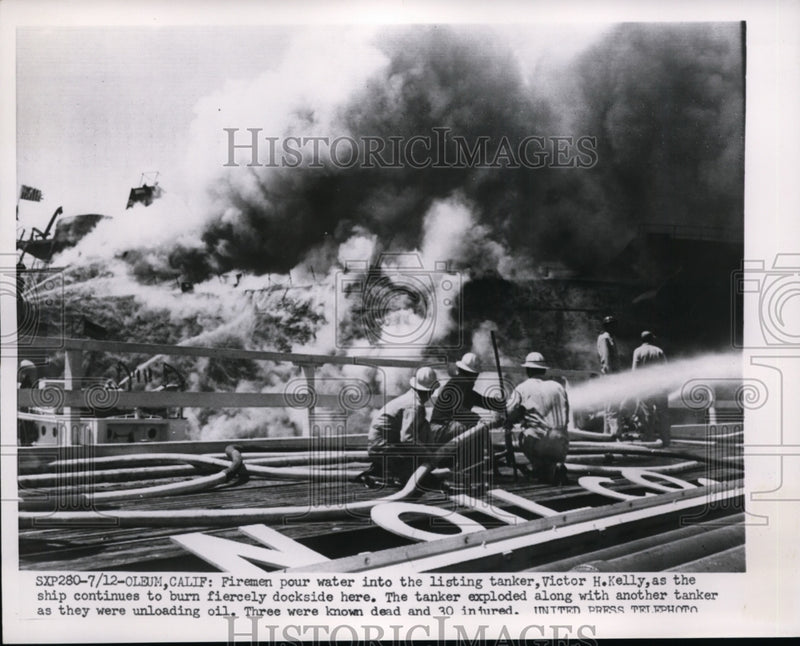 Load image into Gallery viewer, 1952 Press Photo Firemen Pour Water Into The Burning Tanker - nee86523
