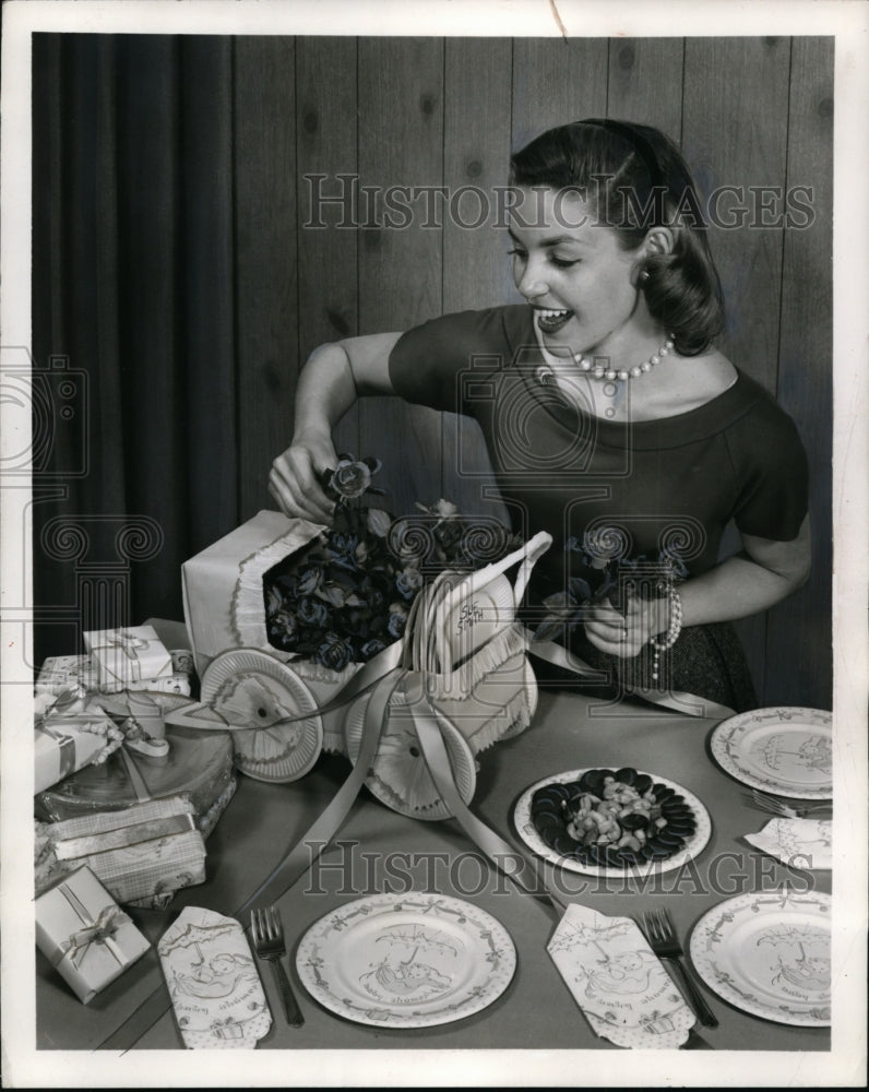 1957 Press Photo A woman preps a display for a shower party at her home