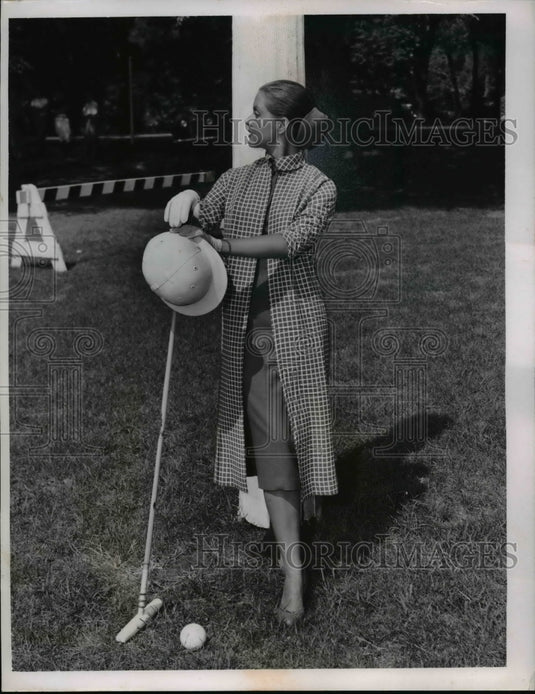 1956 Press Photo A woman models a coat outfit at a cricket field - nee89732