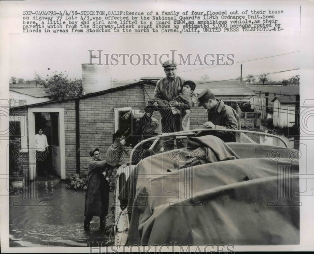 1958 Press Photo Family rescued on their flooded home on Highway 99, California