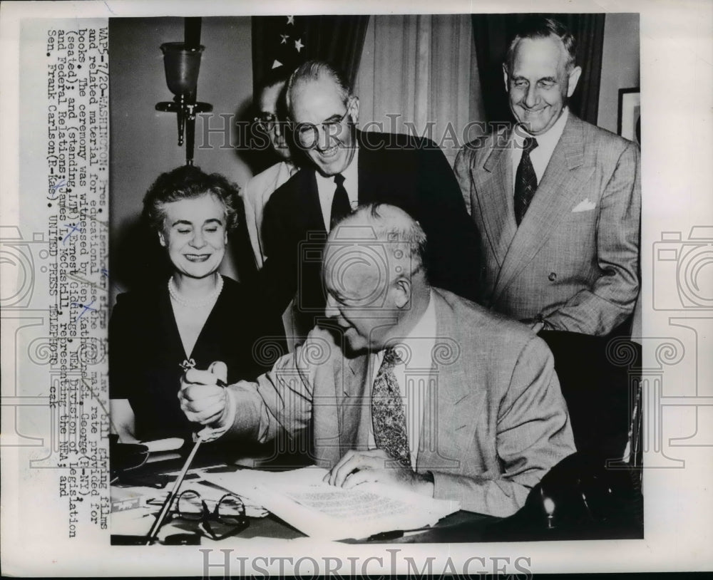 1953 Press Photo Pres.Eisenhower signs into law a bill at the White House