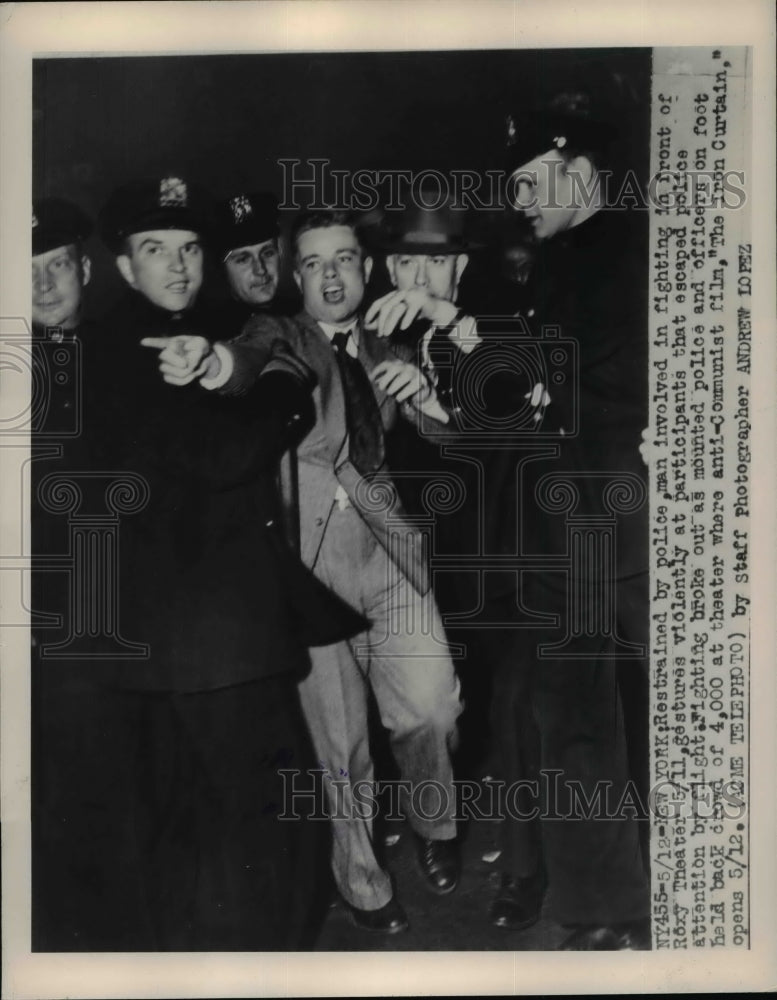 1948 Press Photo Man involved in fighting in front of Roxy Theater arrested