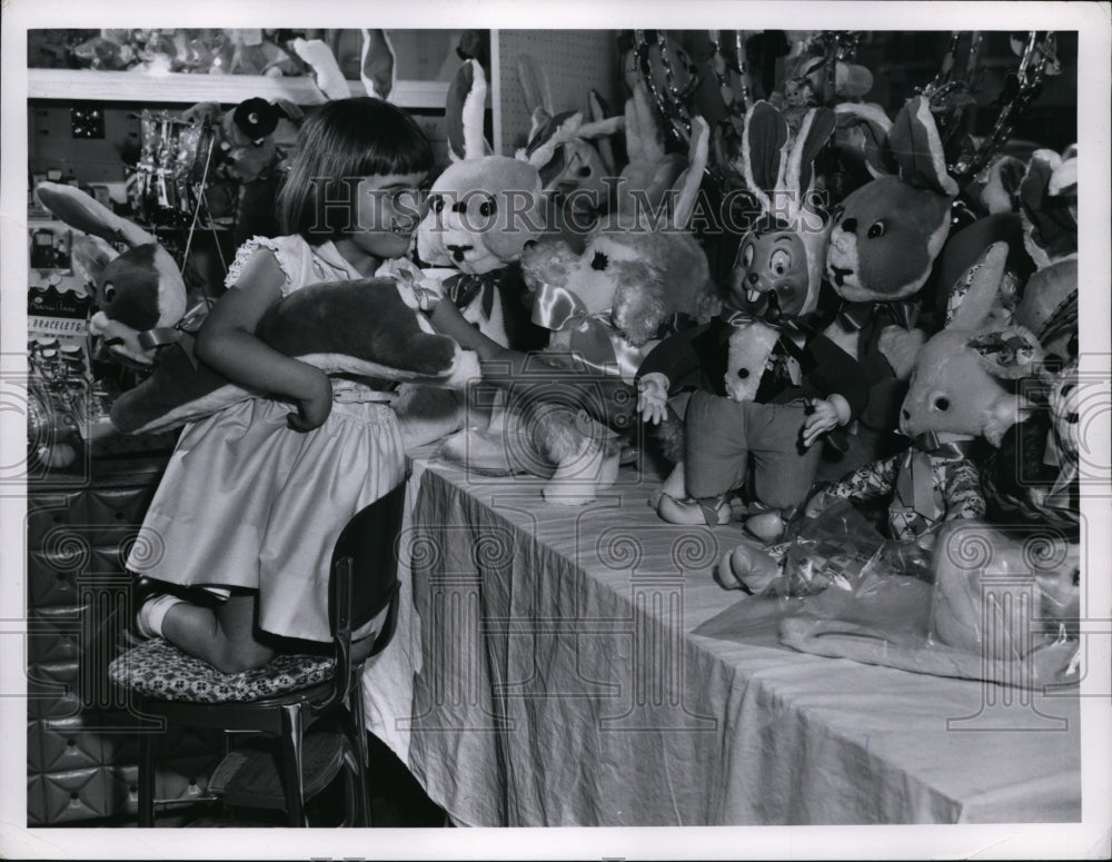1960 Press Photo Connie Ann Wroflewski loos at toy rabbits - nef00185